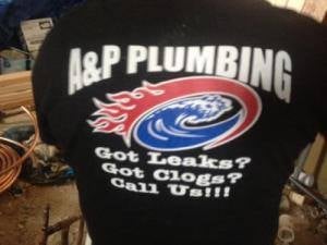 Black J&P Plumbing promotional t-shirt with flaming water logo and text Got Leaks? Got Clogs? Call Us!